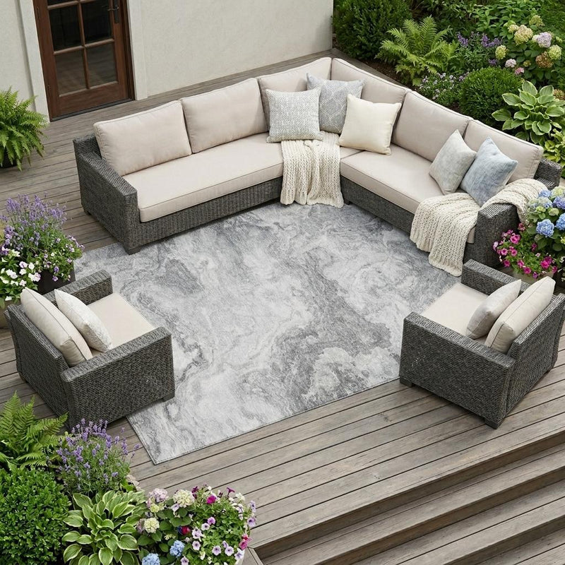 Gray and silver abstract washable area rug under outdoor seating set, square corner view.