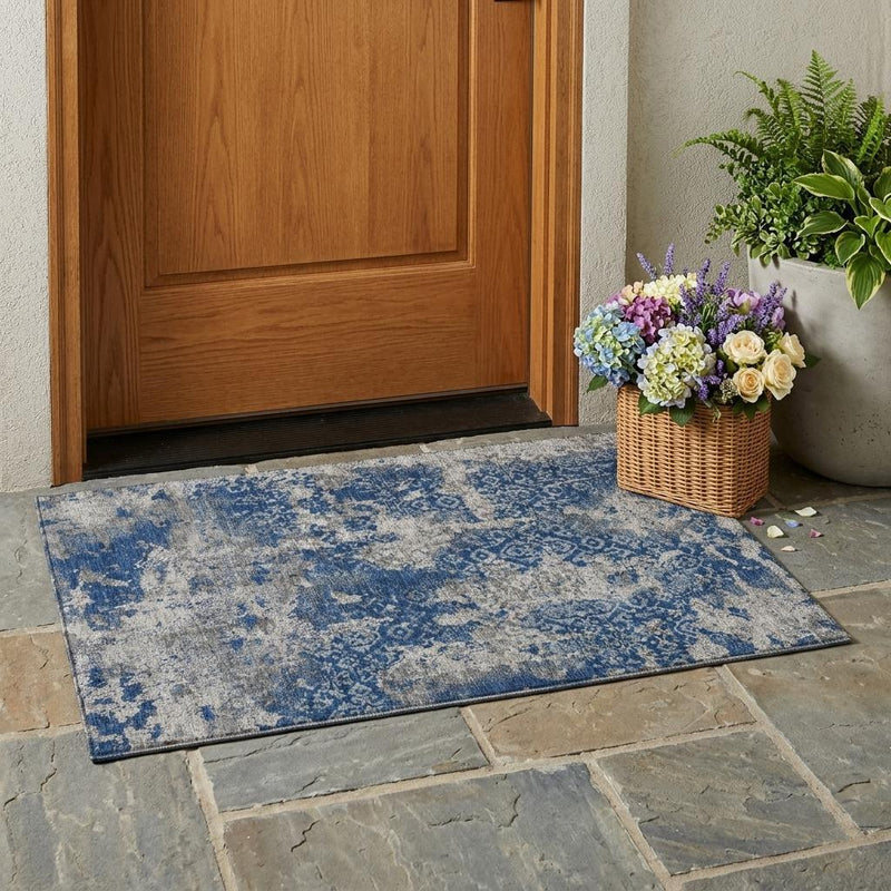 Rectangular abstract indoor/outdoor area rug, navy and light blue distressed wash