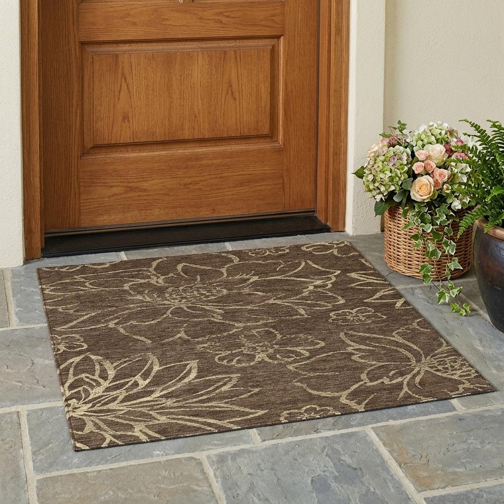 Brown floral area rug at doorway with visible border and pattern