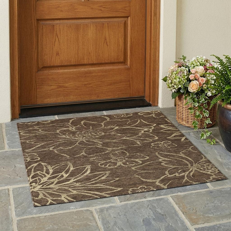 Brown floral area rug at doorway with visible border and pattern