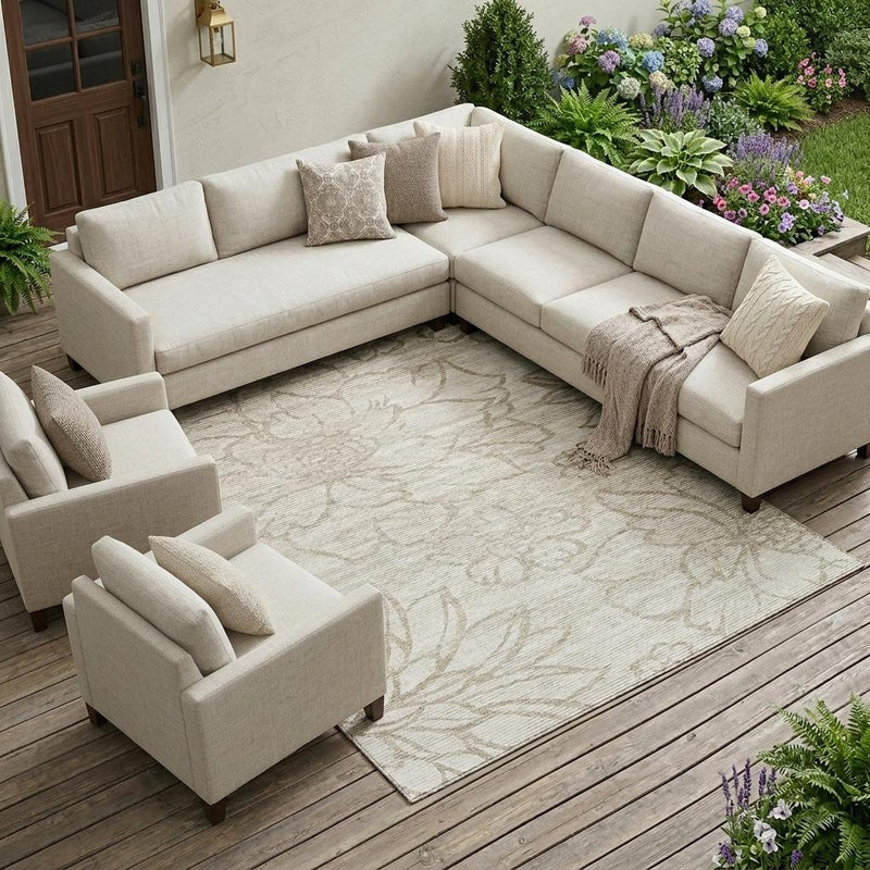 Ivory and silver floral area rug laid flat in an outdoor living space