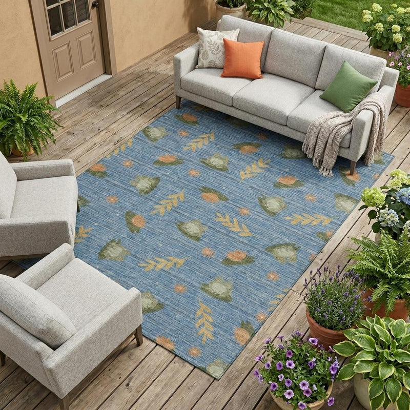 Blue botanical leaf area rug with olive green and orange leaf and feather pattern