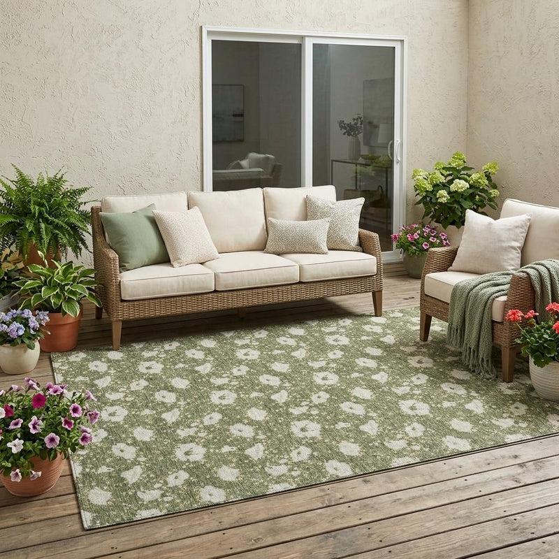 Olive green outdoor area rug with distressed white floral medallions, full view