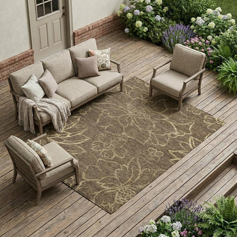 Floral area rug in chocolate and cream tones with distressed botanical pattern