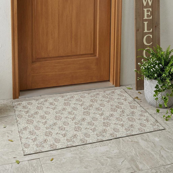 Ivory area rug with light floral medallion pattern and a bordered edge