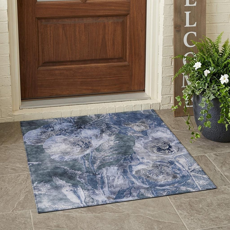 Indoor outdoor area rug with faded blue and lavender floral design and flat weave
