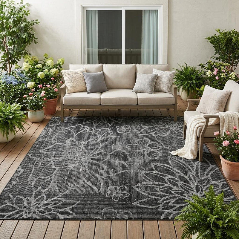 Graphite and black floral patterned area rug with textured, washable weave