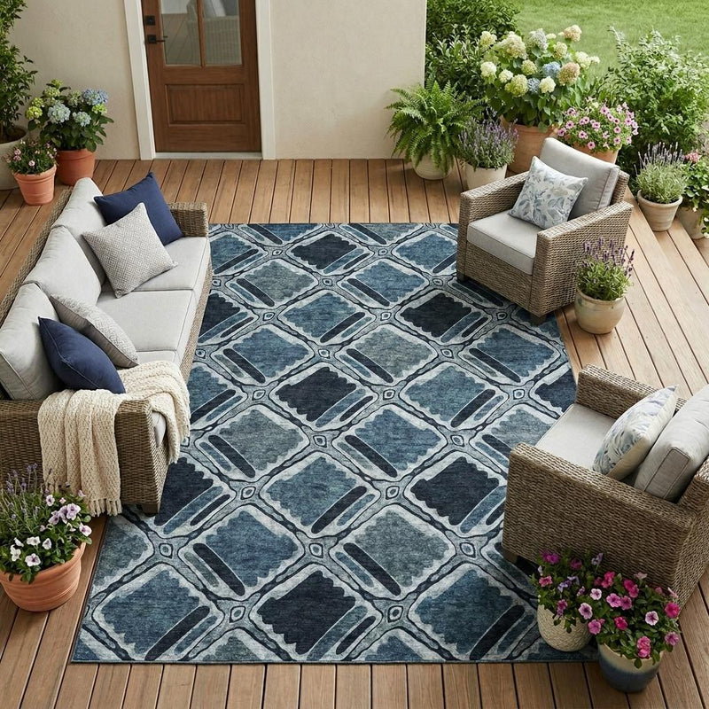 Blue and graphite geometric area rug on a wooden outdoor floor