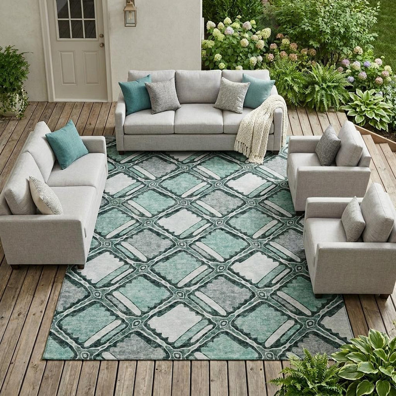 Indoor/outdoor geometric area rug in teal and aqua with gray accents