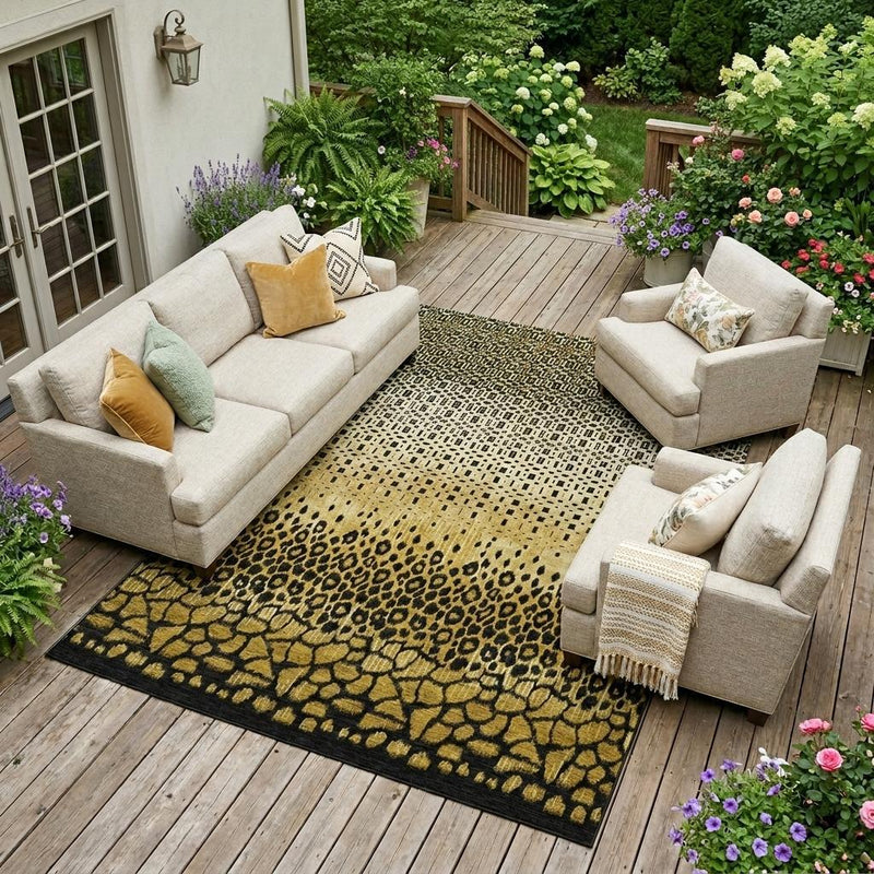 Rectangular gold and black geometric animal-print outdoor area rug on deck