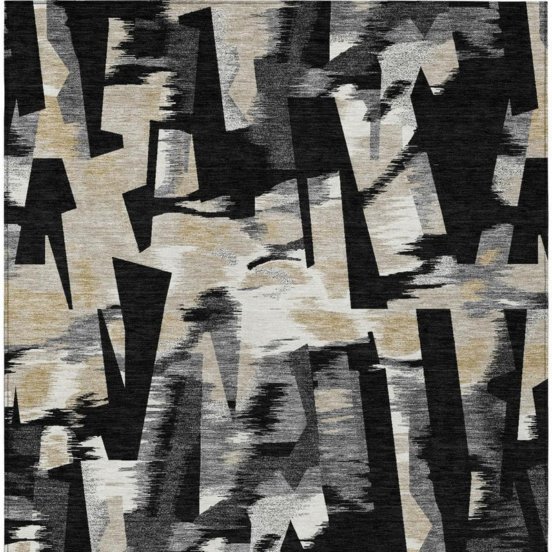 Abstract area rug close-up with black and graphite geometric strokes on beige.