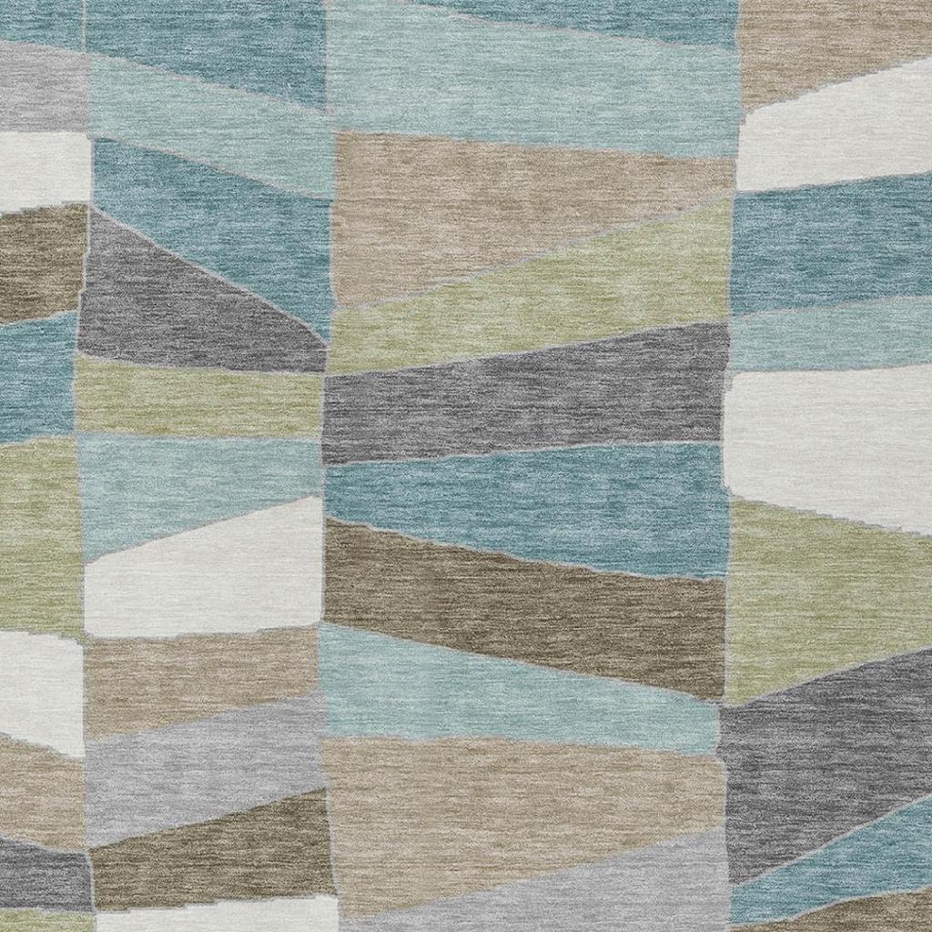 Geometric patchwork area rug with aqua, beige, gray, white, and muted green blocks