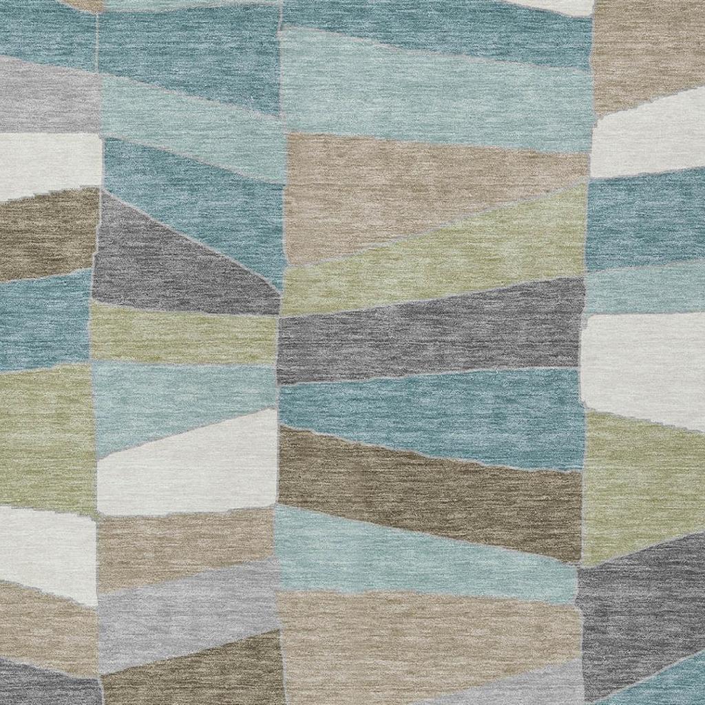 Geometric patchwork area rug with teal, beige, gray, and cream stripe and block shapes
