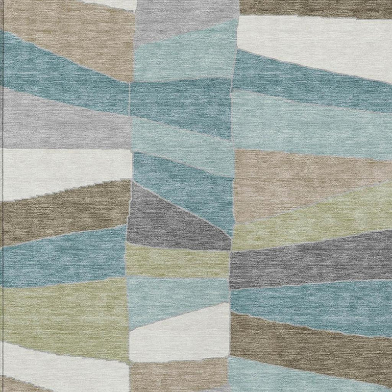 Teal blue geometric patchwork area rug with beige, gray, and cream block pattern