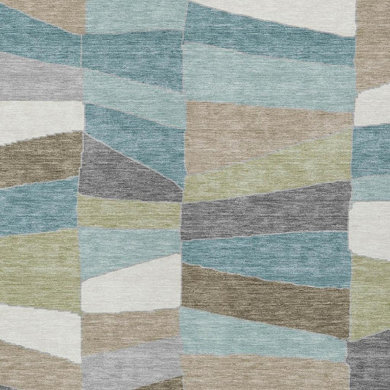 Rectangular geometric patchwork area rug in teal, beige, gray, white, and soft green tones