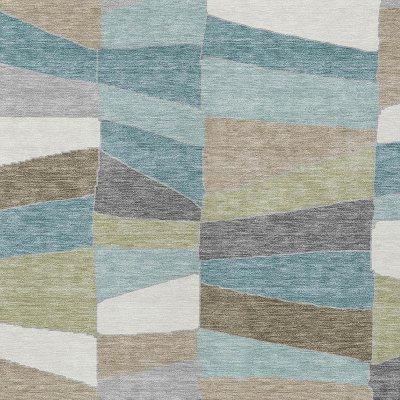Geometric area rug close-up of teal, beige, gray, and white stripe-like blocks