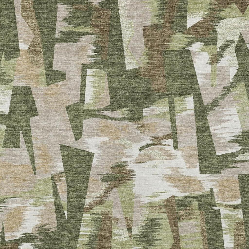 Olive green abstract area rug close-up with cream geometric shapes and distressed texture.