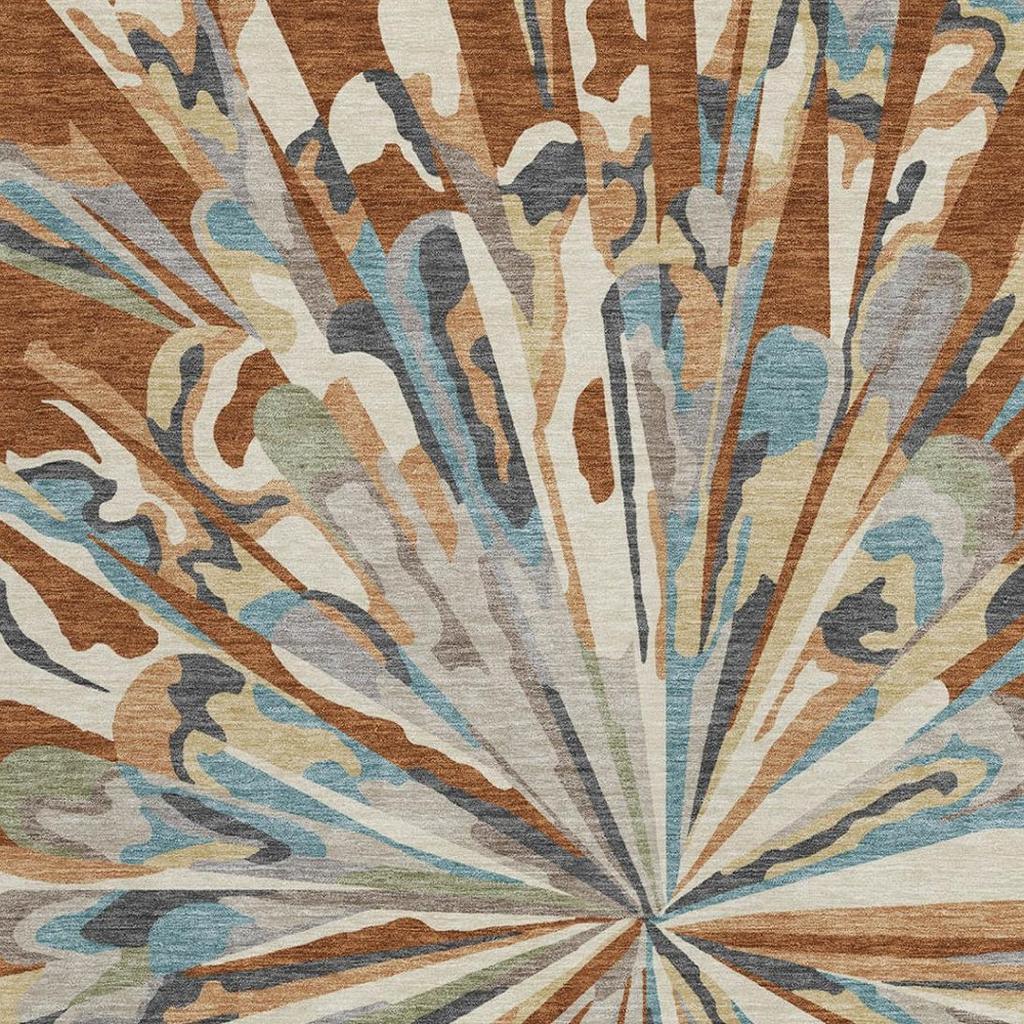Abstract rug detail showing sunburst rays in teal, orange, brown, and cream on textured pile