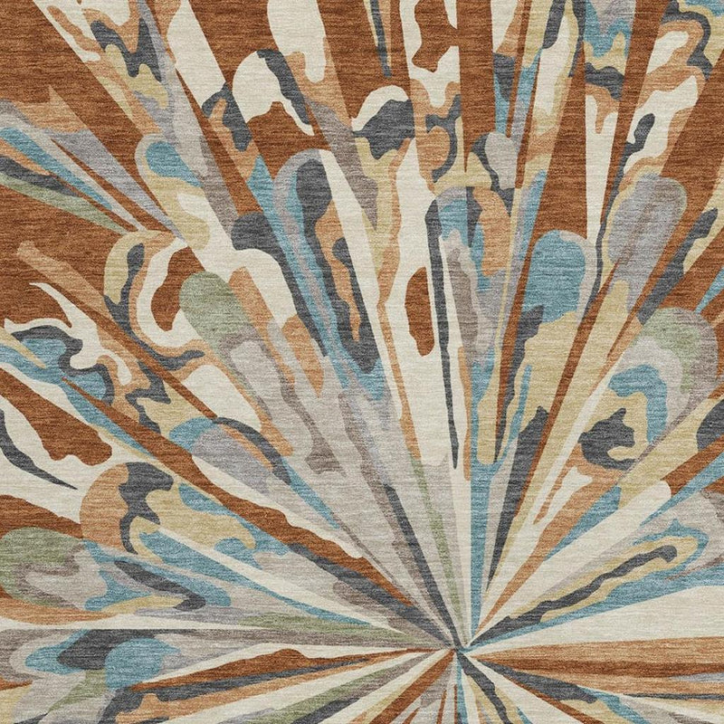 Abstract rug detail showing sunburst rays in teal, orange, brown, and cream on textured pile