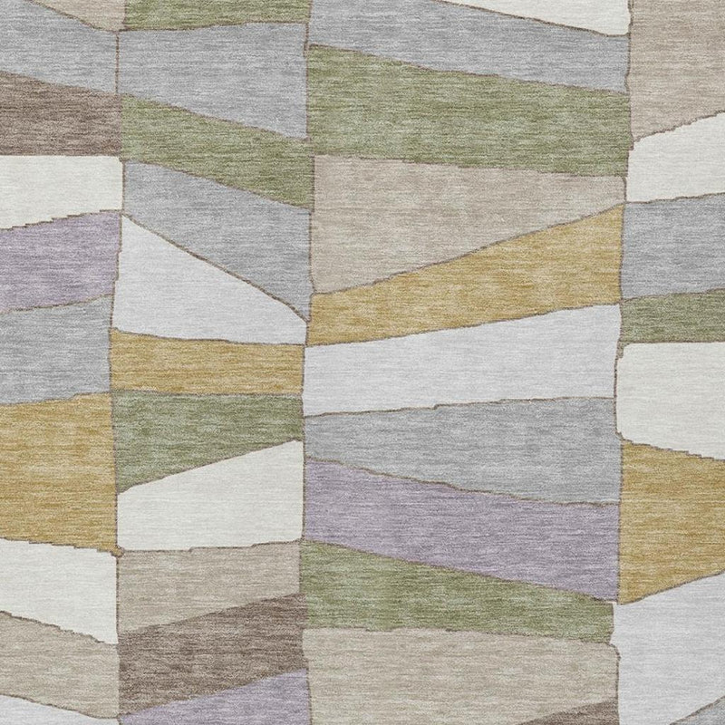 Geometric area rug featuring layered cube blocks in gray, green, purple, and gold