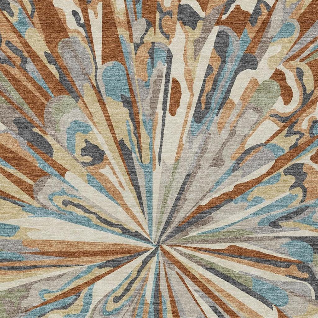 Rug close-up showing central sunburst and swirling rays in teal, orange, cream, and brown