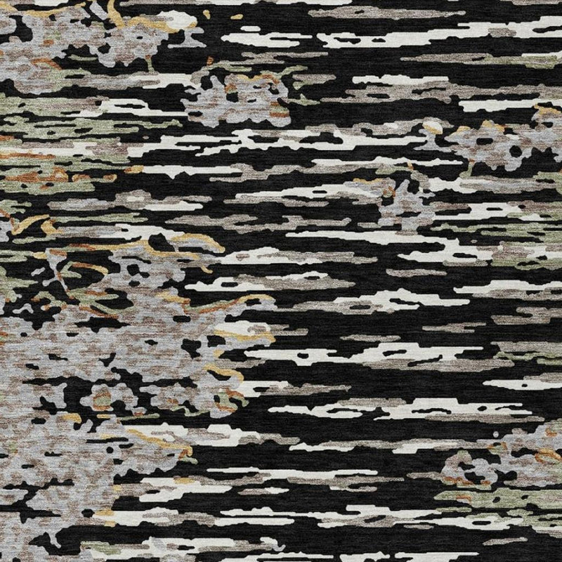 Abstract area rug close-up with black, gray, and olive distressed stripe and speckle design