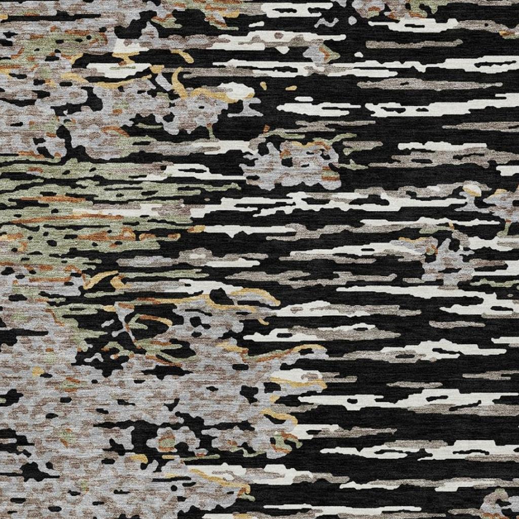 Abstract area rug with black, gray, and graphite horizontal blocks and speckled texture