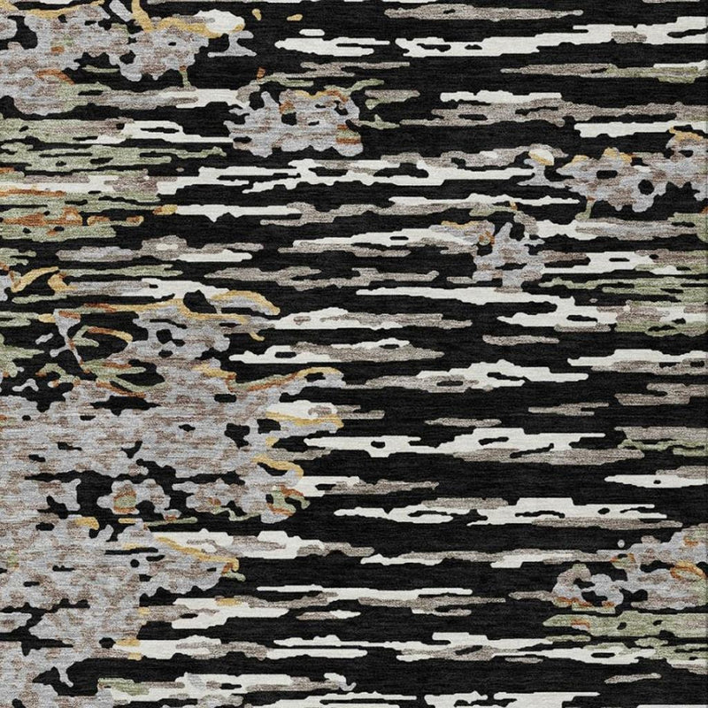 Abstract area rug close-up with black, gray, and cream distressed lines