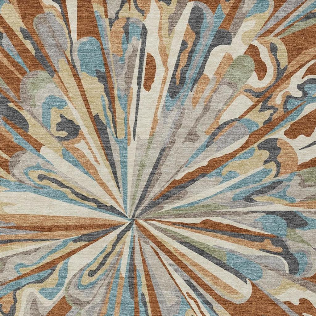 Close-up of abstract sunburst rug pattern in teal, orange, and gray on a light background.
