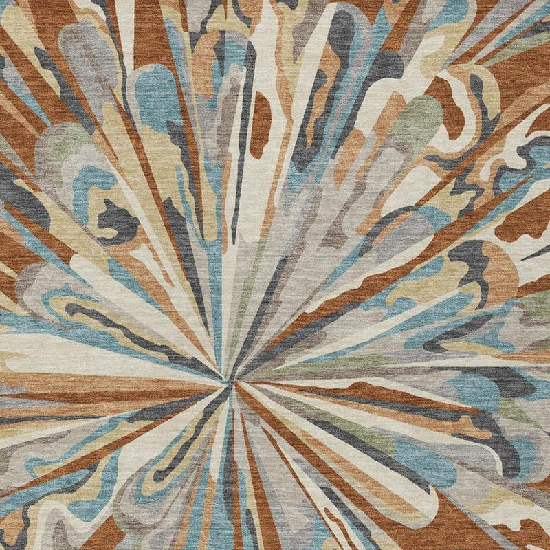 Close-up of abstract sunburst rug pattern in teal, orange, and gray on a light background.