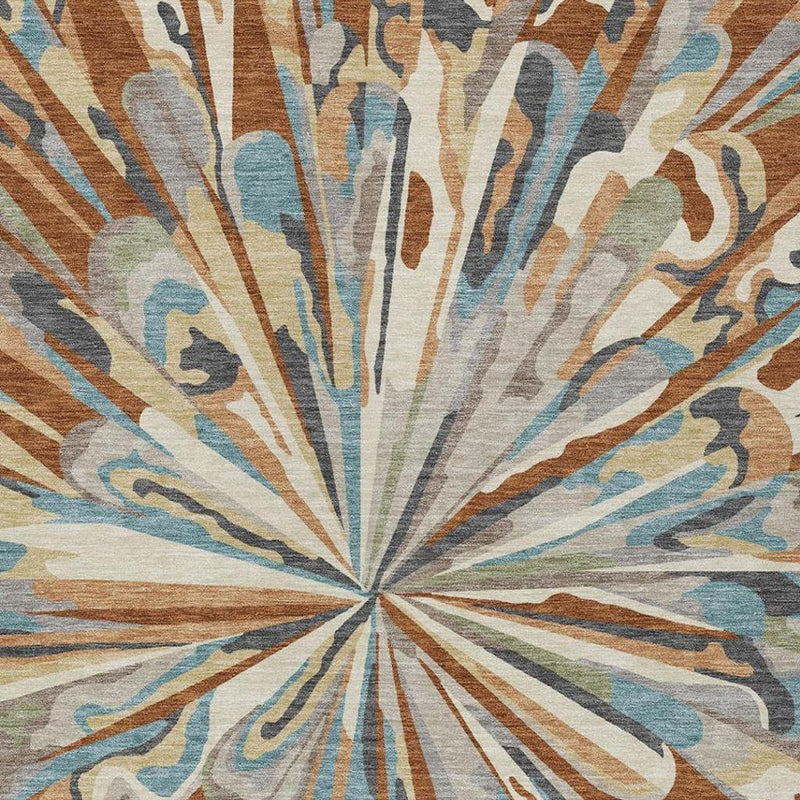 Close-up of abstract radial rug design with orange, teal, cream, and gray streaks.