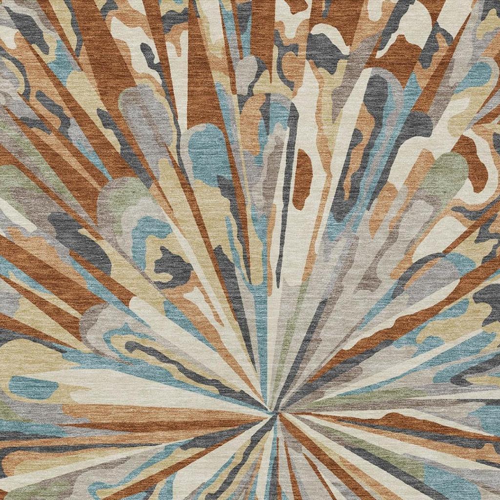 Tight view of abstract sunburst rug pattern in teal, orange, and muted green-gray tones.