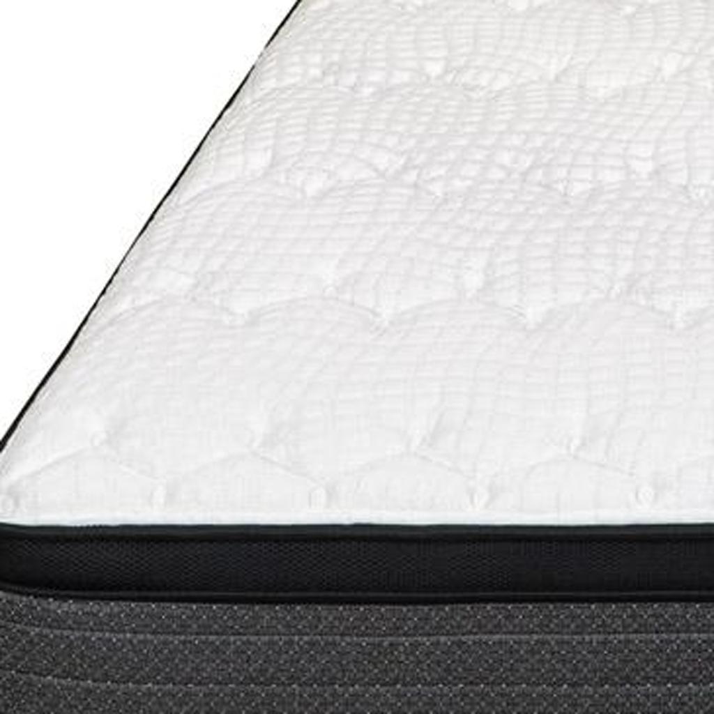 White quilted mattress with black fabric border, offering a modern design and comfort for a restful sleep.