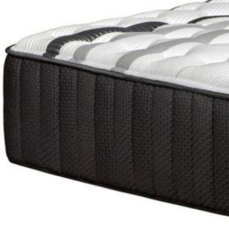 Close-up of dark charcoal twin hybrid mattress side with quilted white top edge