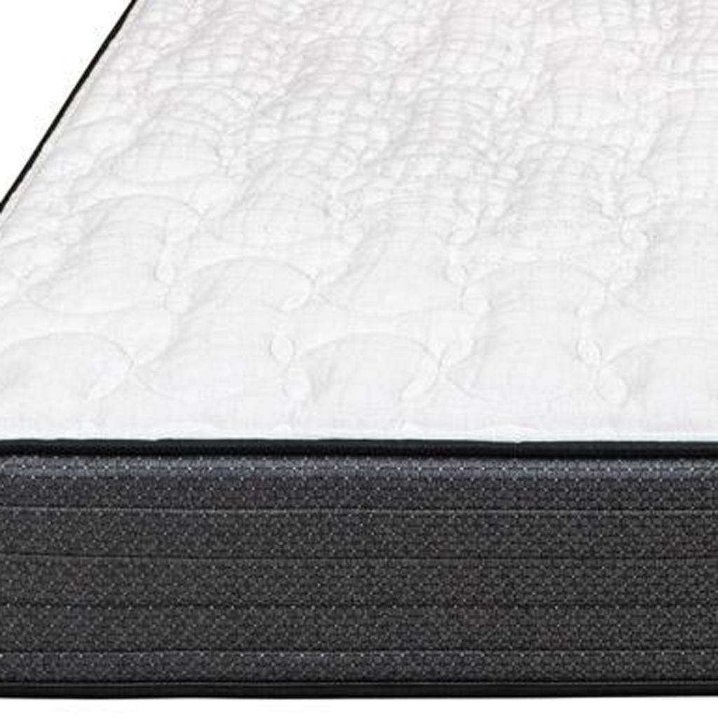 White quilted mattress with a black foam base, offering comfort and support for restful sleep.