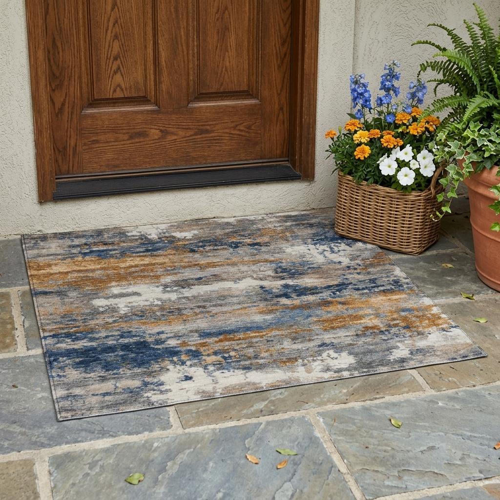 Colorful abstract outdoor rug in blue, orange, and gray, perfect for entranceways or patios. Durable and stylish design.