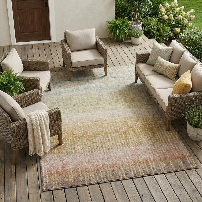 Abstract indoor outdoor area rug with wheat, gold, and muted pink wash pattern