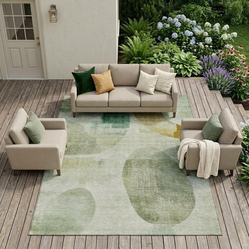 Green and ivory geometric area rug under outdoor seating, flat patterned surface