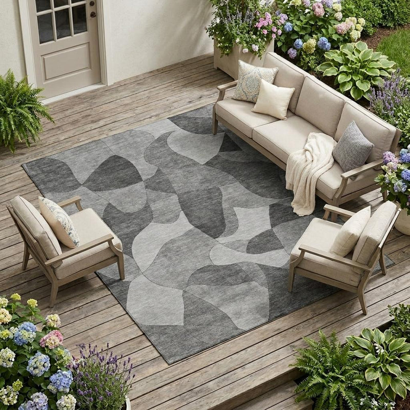 Gray and silver abstract area rug laid on an outdoor patio floor