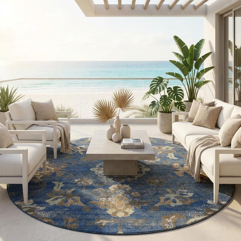 Round blue area rug with cream and gold floral medallion pattern