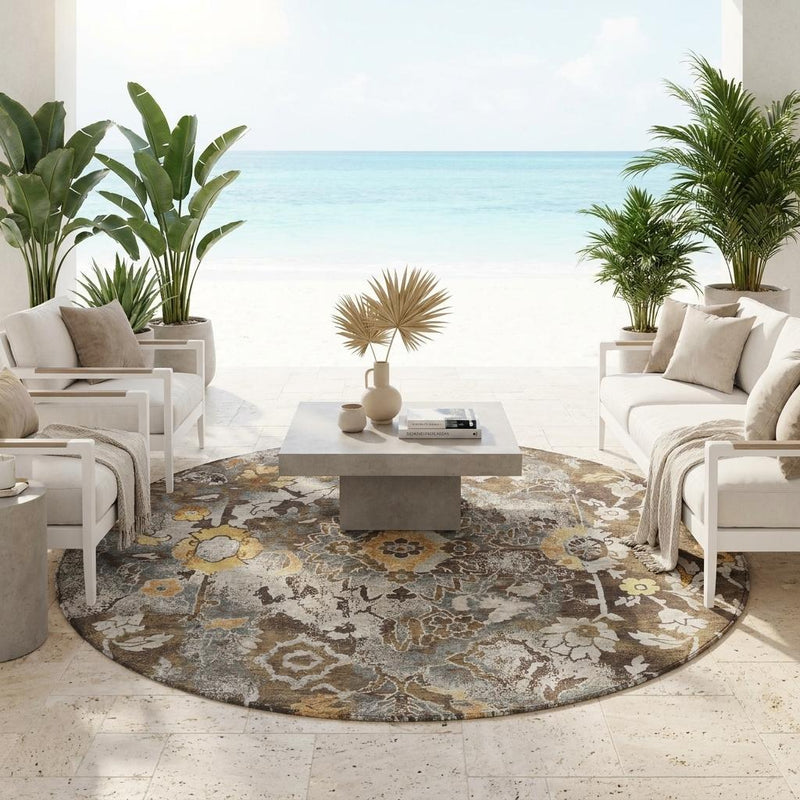 Round washable indoor/outdoor area rug with distressed floral pattern in brown and beige