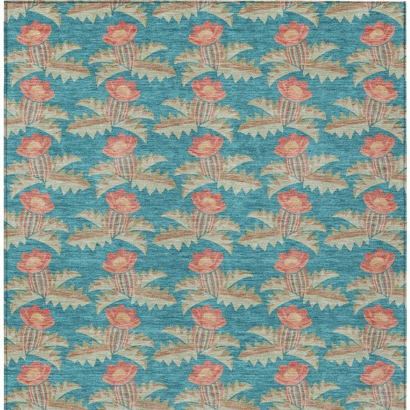 Turquoise floral area rug with coral tulip-like flowers and zigzag shapes