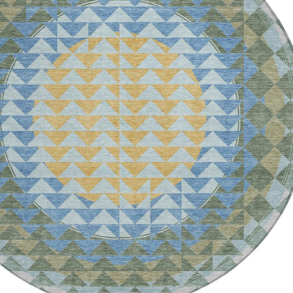 Round area rug with geometric chevron pattern in blue, silver, green, and yellow