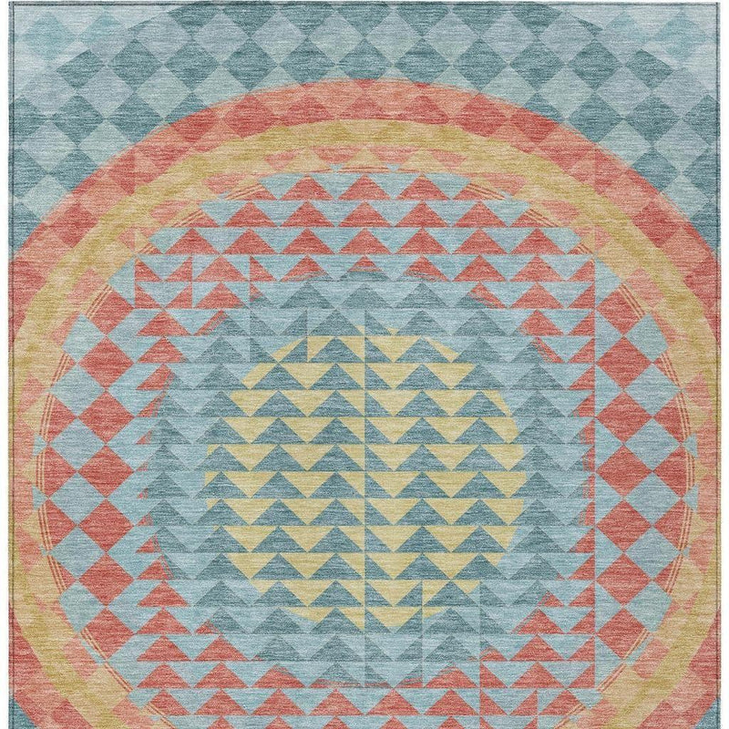 Teal blue geometric area rug with circular border and chevron center in coral, yellow, gray