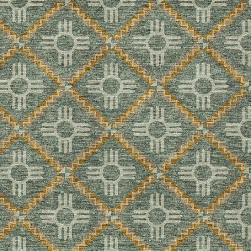 Close-up of teal-green rug fabric with cream sun-hand icons and gold diamond borders