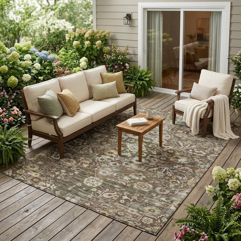 Indoor/outdoor area rug with distressed medallion floral pattern, brown, green, beige