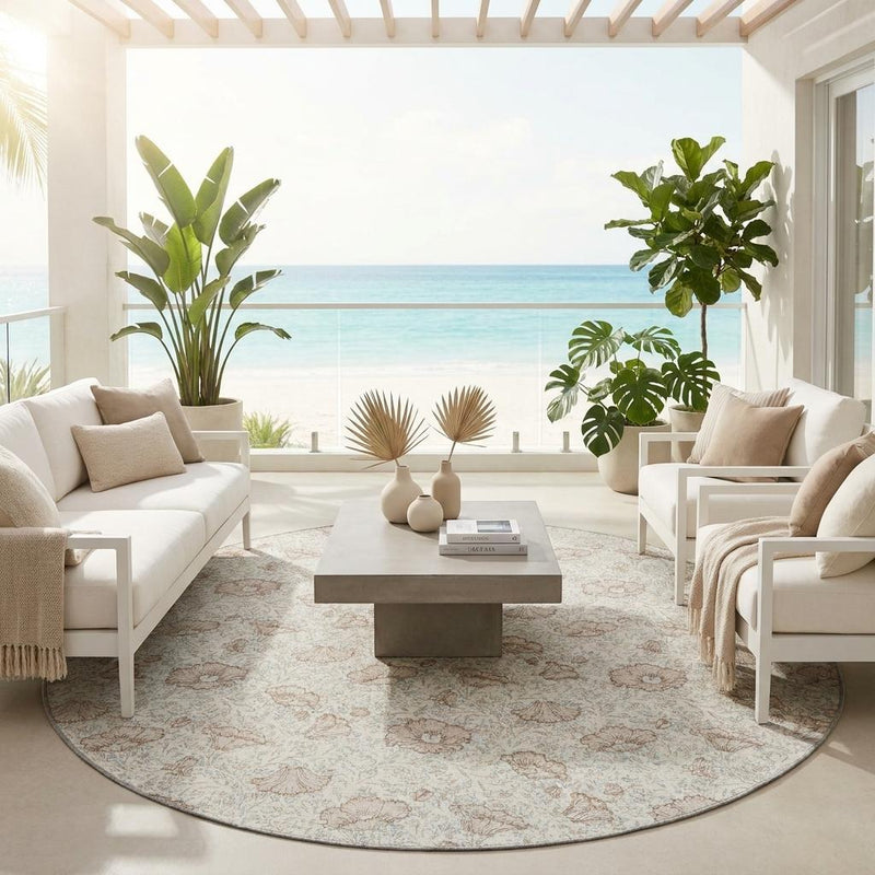 Round ivory floral area rug with light border pattern on the floor.