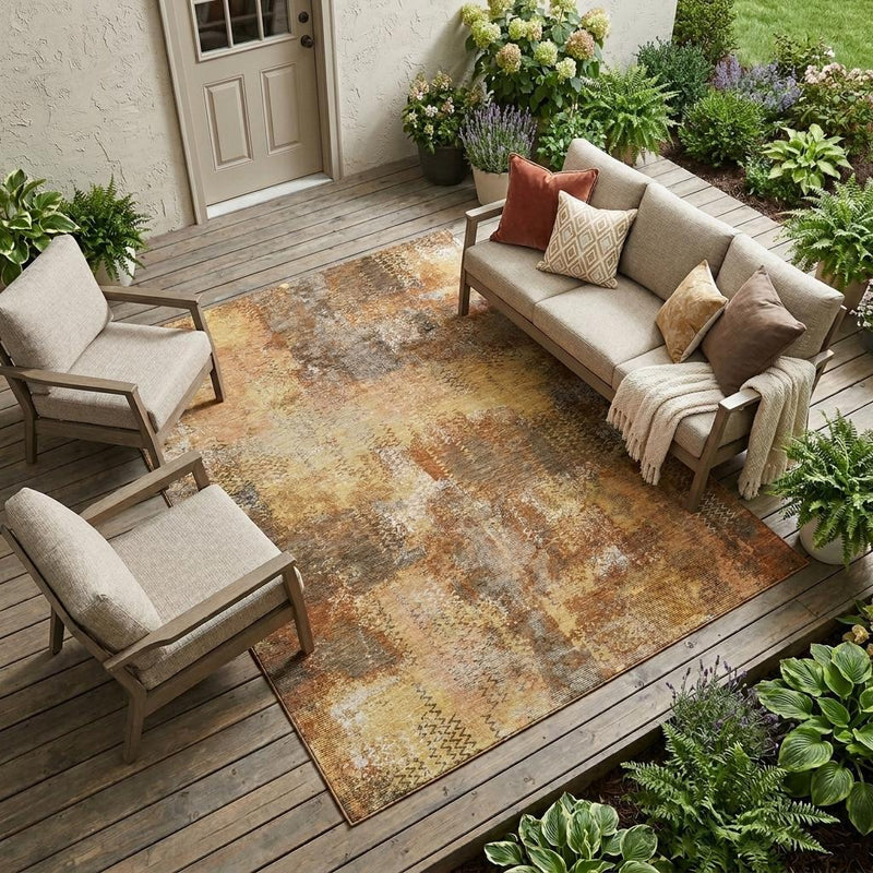 Indoor outdoor area rug with copper, tan, and orange abstract mottled wash
