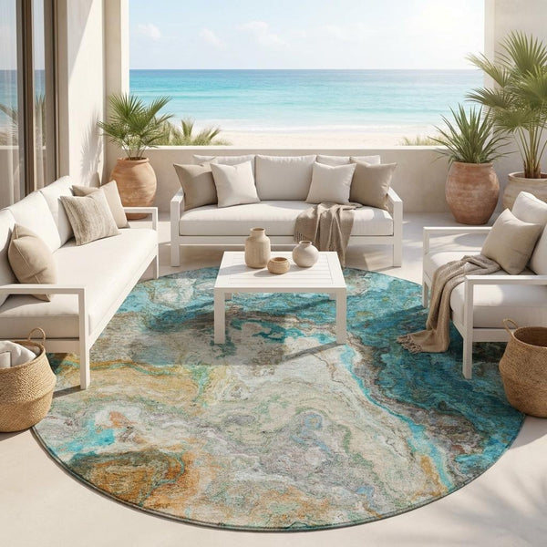 Round abstract area rug in aqua, teal, and tan with textured distressed pattern