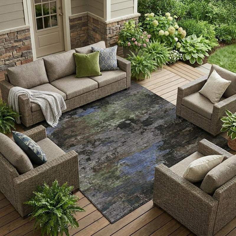 Abstract area rug with gray base and blue-green distressed patches